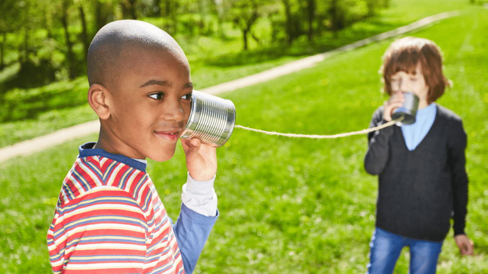 Two children talking through a phone